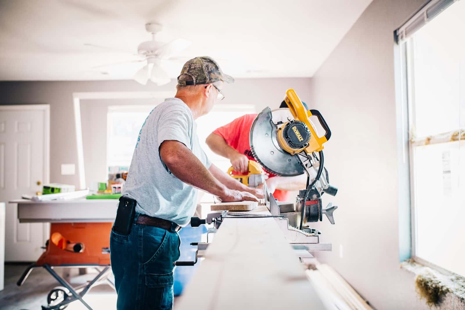 Construction crew working on a remodel for owner compensation tax planning