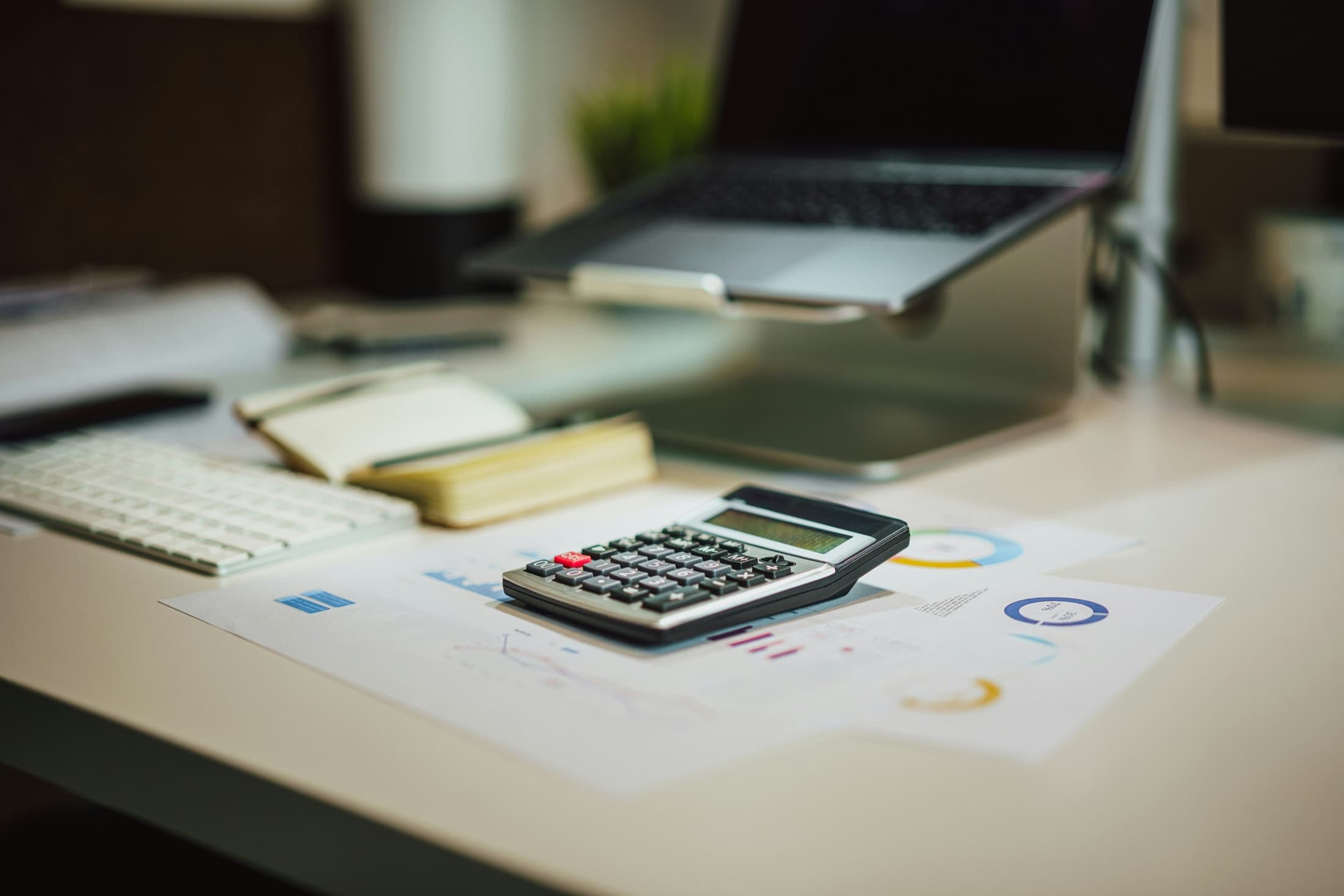 Calculator and financial reports used for business tax planning