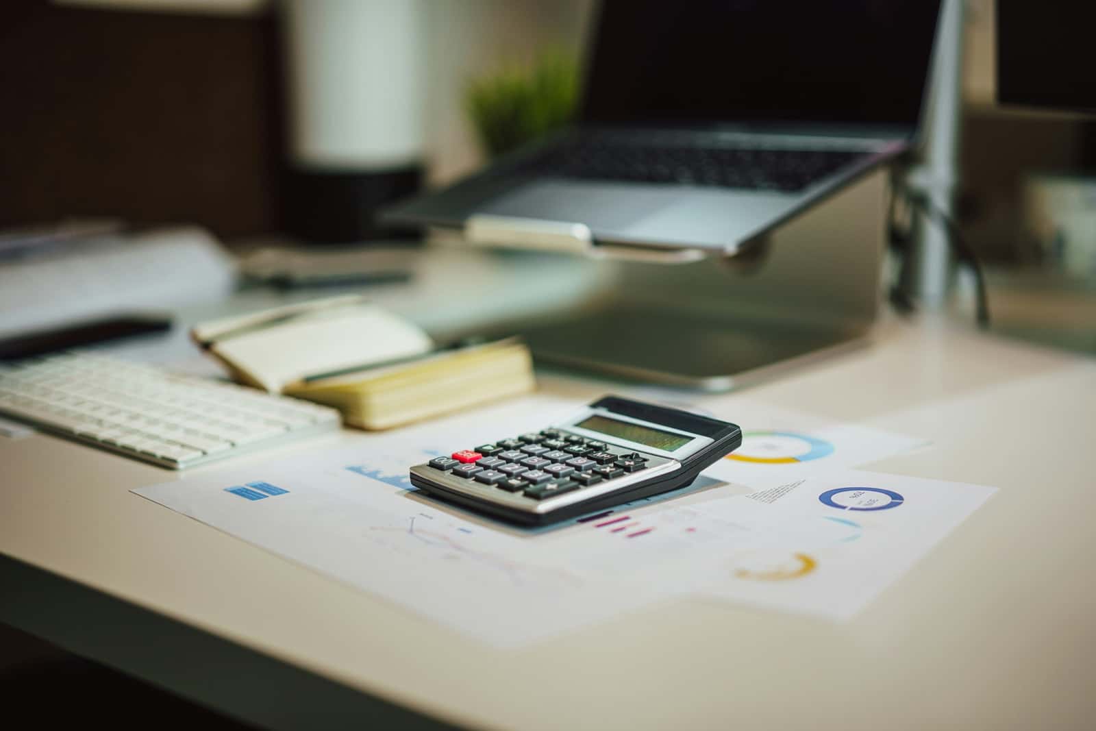Calculator and financial reports used for business tax planning