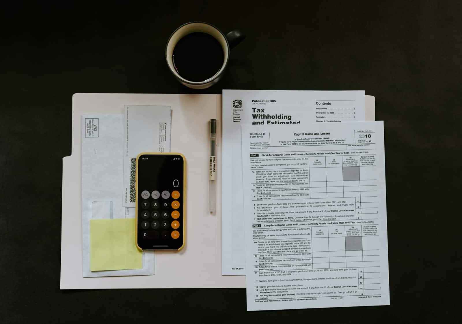 Tax forms, calculator, and planning documents on a desk