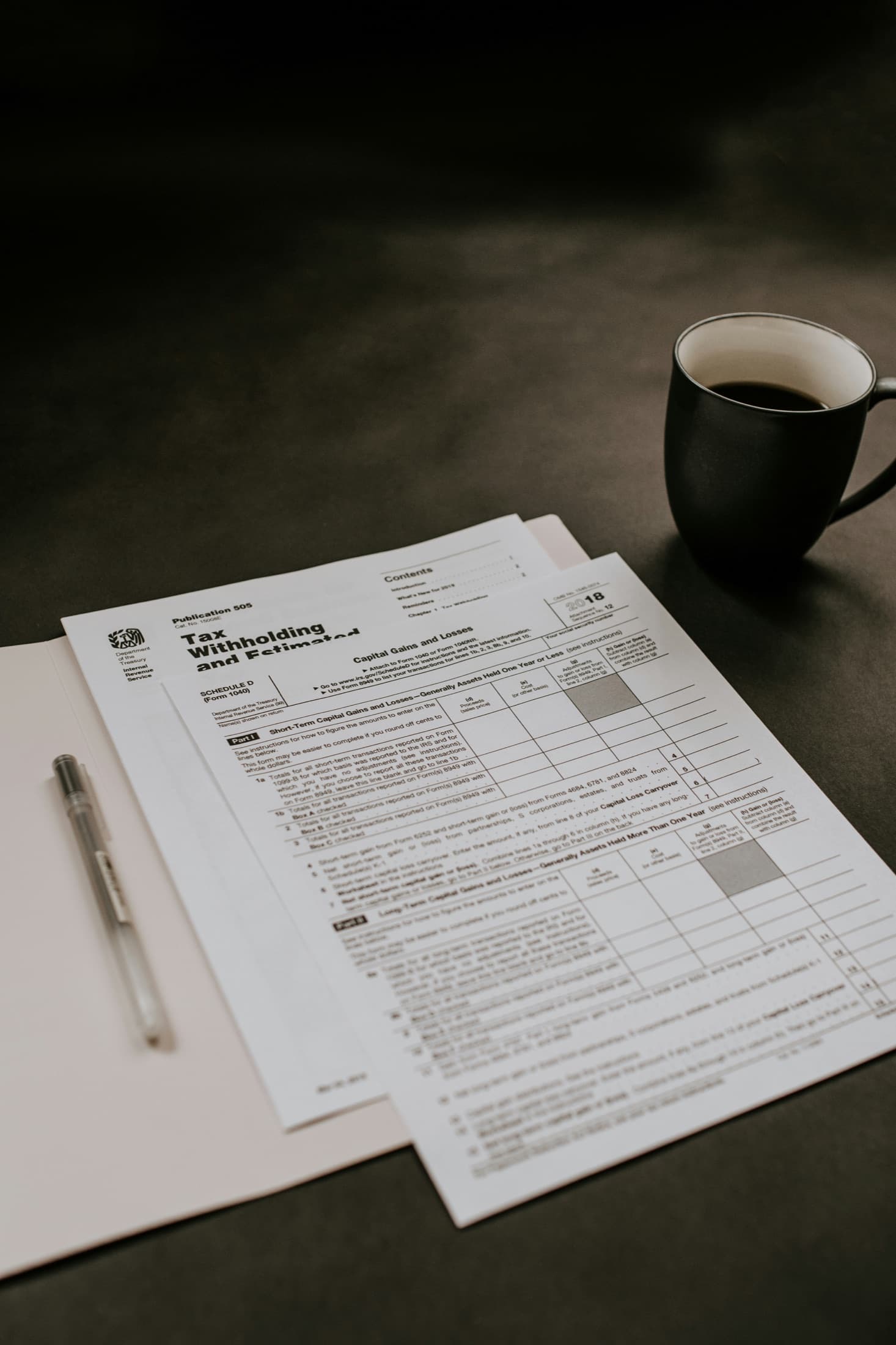 Tax forms and coffee arranged for a planning review