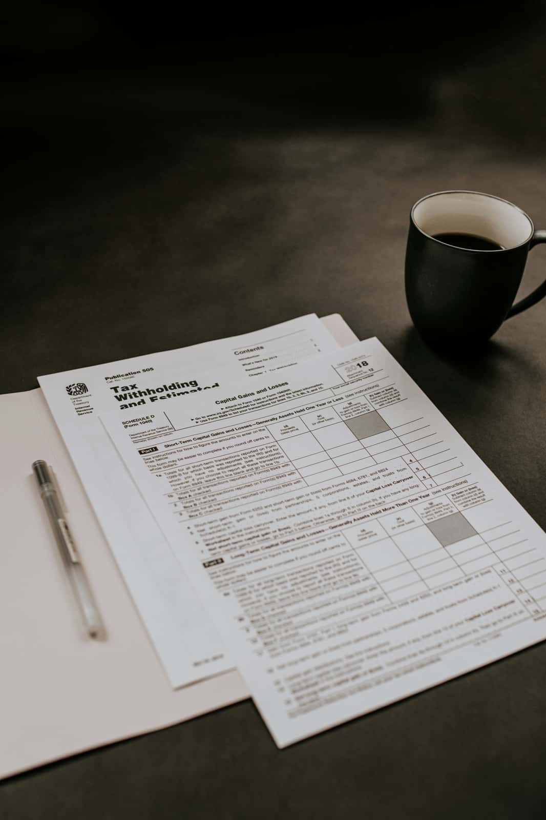 Tax forms and coffee arranged for a planning review