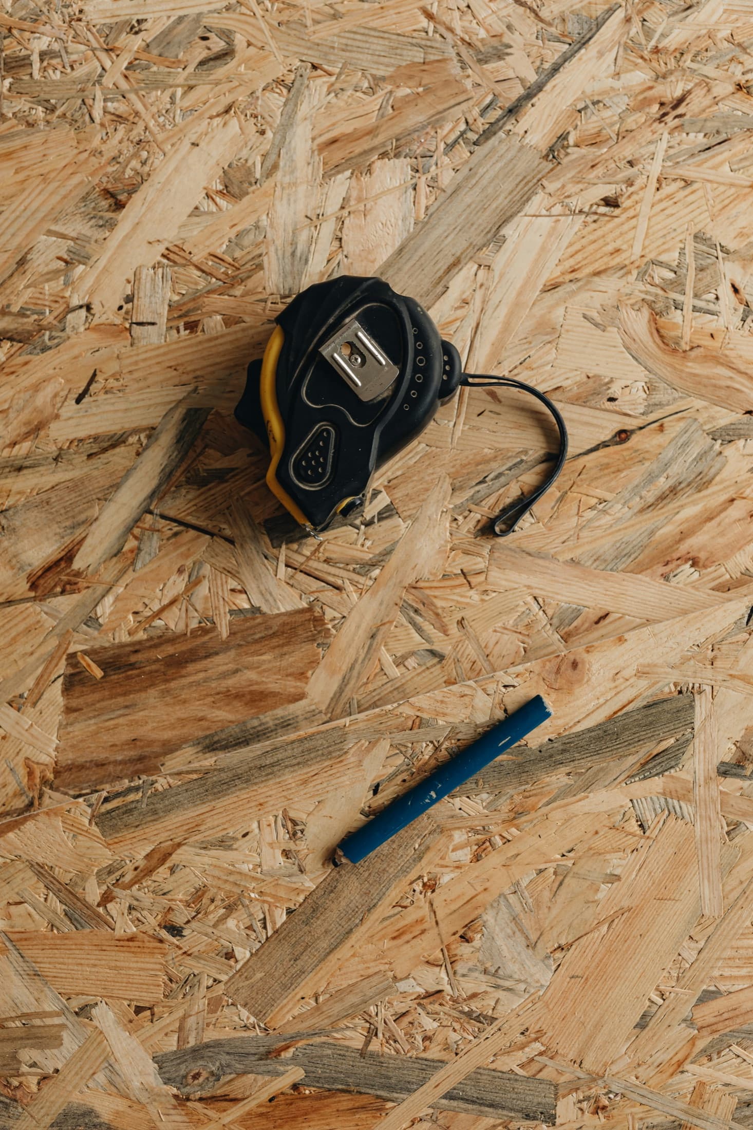 Measuring tape and contractor tools representing tax prep versus tax strategy