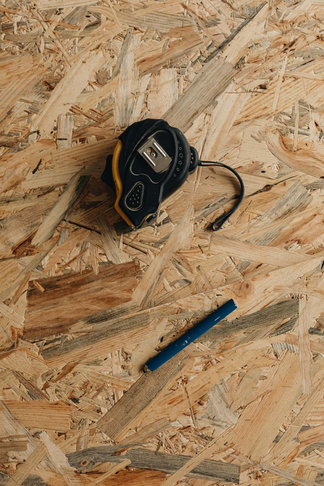 Measuring tape and contractor tools representing tax prep versus tax strategy
