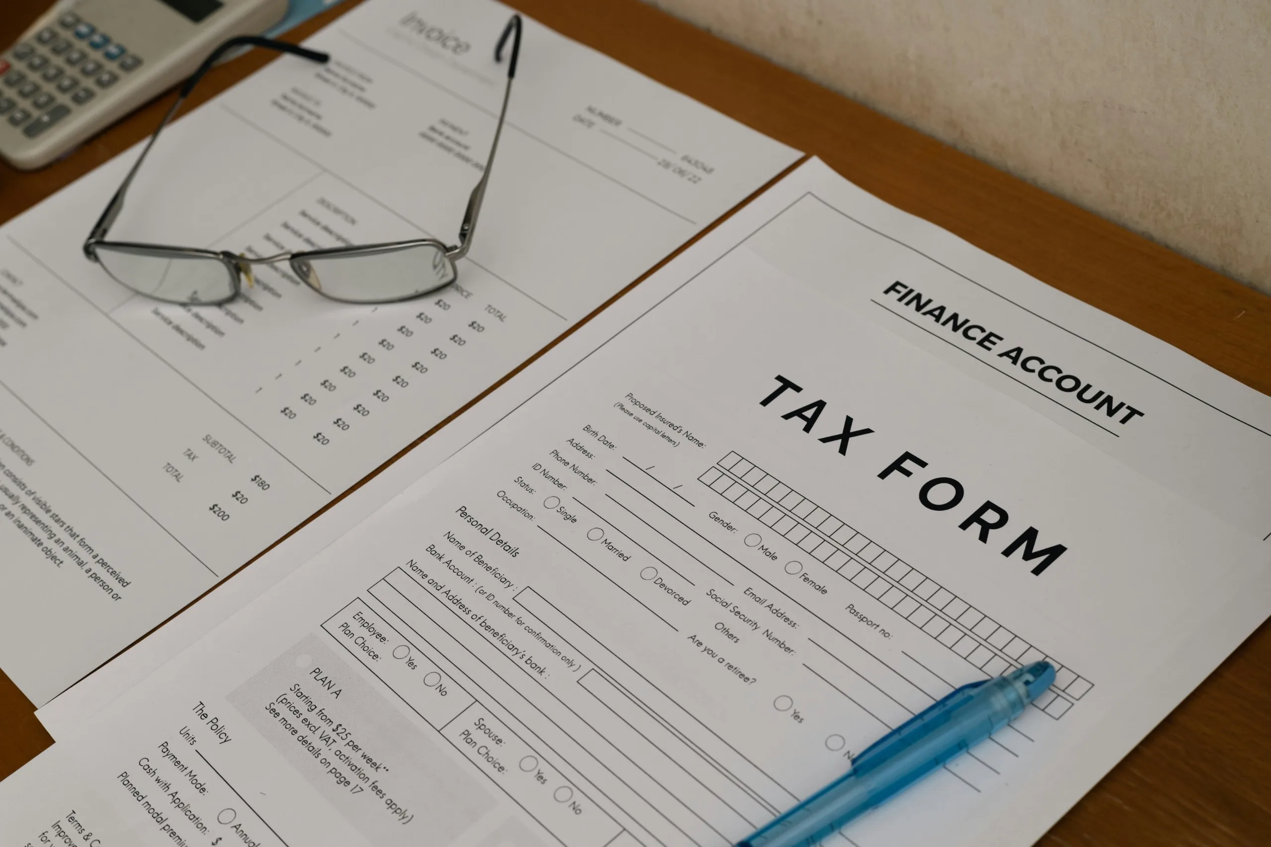 eyes glasses on top of tax forms